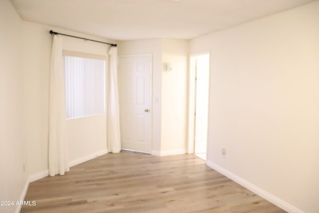 unfurnished room featuring light hardwood / wood-style flooring