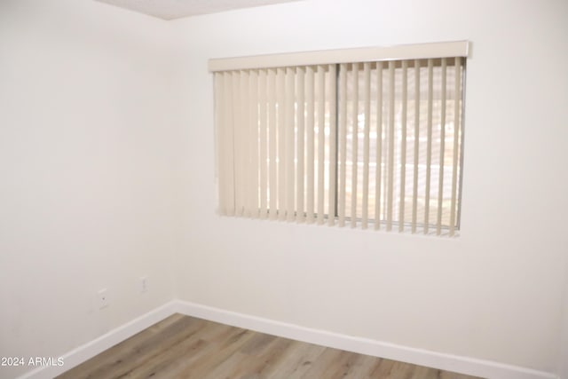 unfurnished room with wood-type flooring