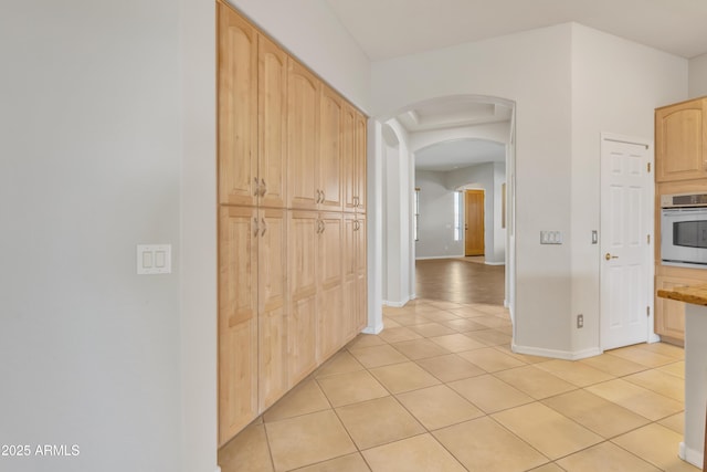 corridor with light tile patterned flooring