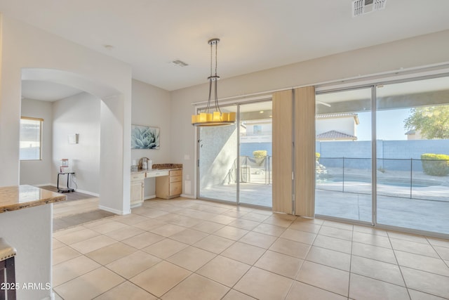 unfurnished dining area with light tile patterned flooring