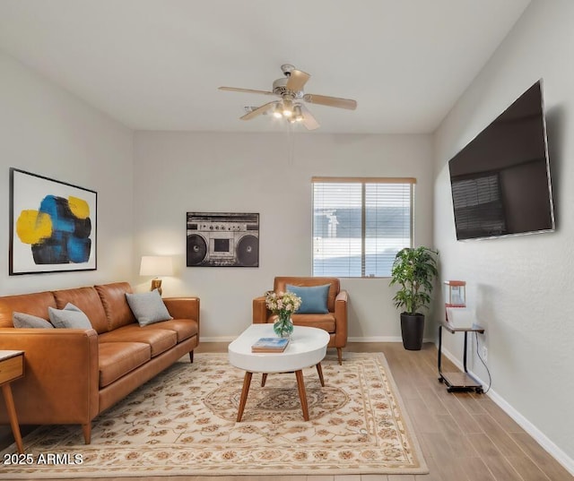 living room featuring ceiling fan and light wood-type flooring