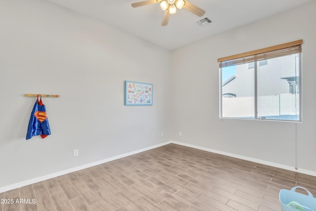 empty room with ceiling fan and light wood-type flooring