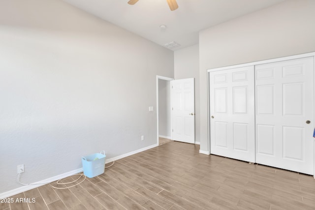 unfurnished bedroom with a closet, ceiling fan, and light hardwood / wood-style flooring