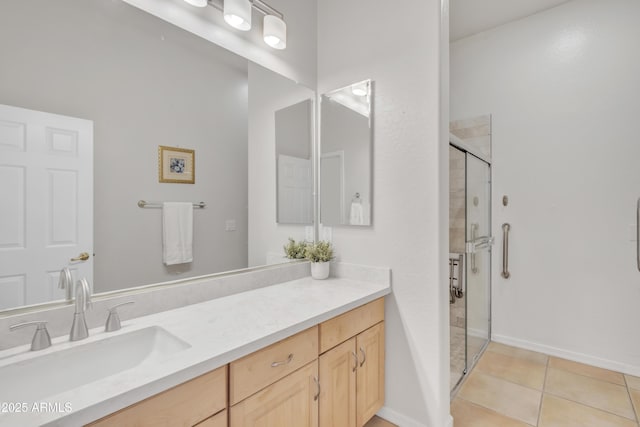 bathroom featuring vanity, a shower with shower door, and tile patterned flooring