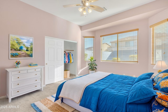 carpeted bedroom with multiple windows and ceiling fan