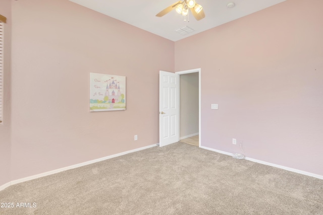 carpeted empty room featuring ceiling fan