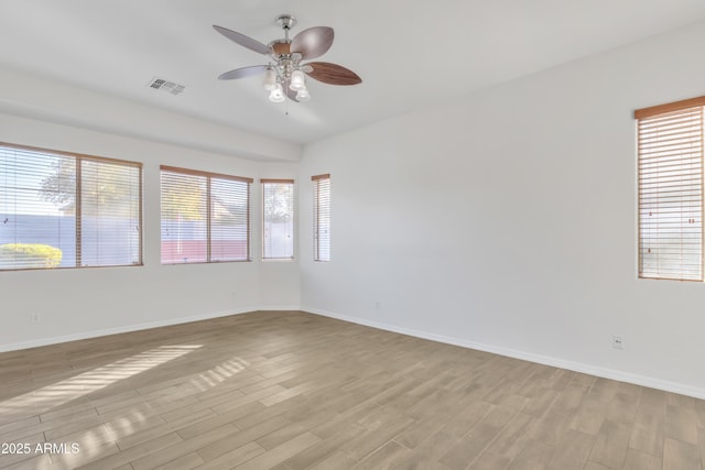 empty room with ceiling fan and light wood-type flooring