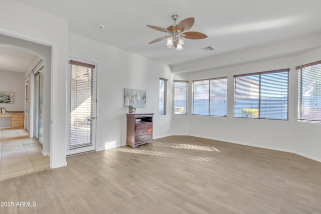 unfurnished living room with ceiling fan and light hardwood / wood-style floors