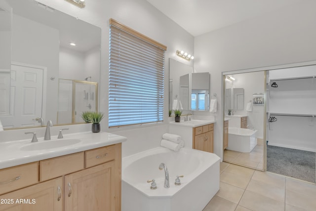 bathroom with tile patterned flooring, vanity, and independent shower and bath