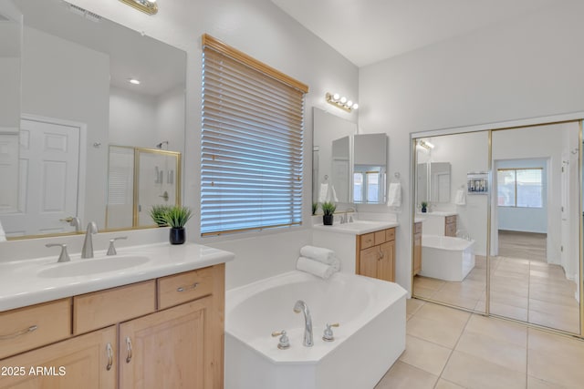 bathroom with tile patterned floors, shower with separate bathtub, and vanity