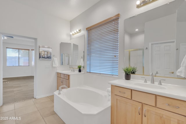 bathroom with tile patterned floors, independent shower and bath, and vanity