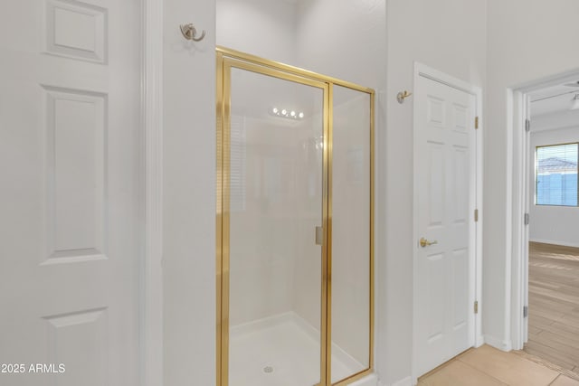 bathroom with tile patterned flooring and a shower with shower door