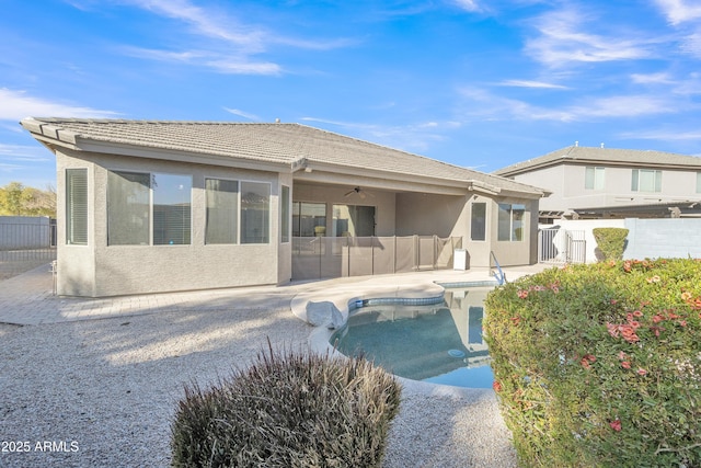 back of house with a fenced in pool and a patio area