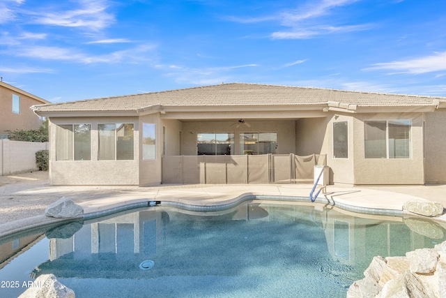 view of pool with ceiling fan and a patio area