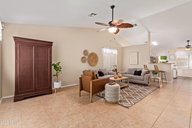 living room featuring ceiling fan, vaulted ceiling, visible vents, and a healthy amount of sunlight