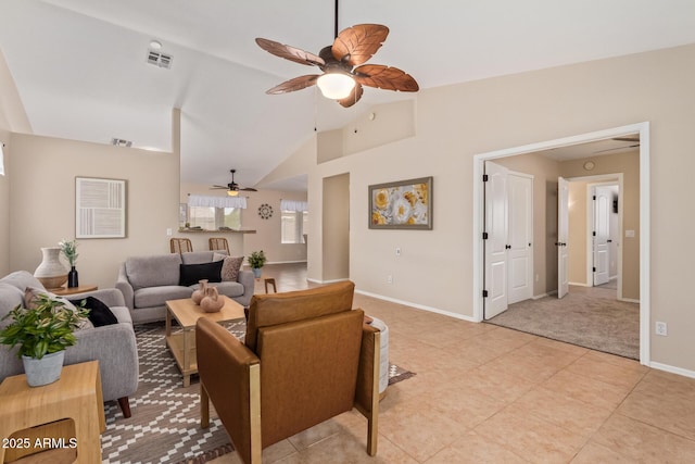 living area featuring light tile patterned floors, baseboards, visible vents, and ceiling fan