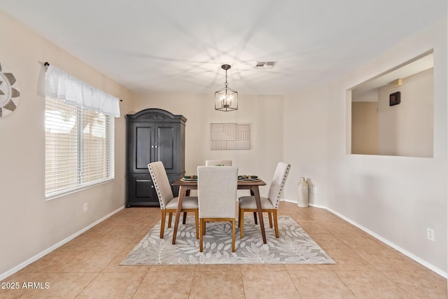 dining area with tile patterned flooring, visible vents, a notable chandelier, and baseboards