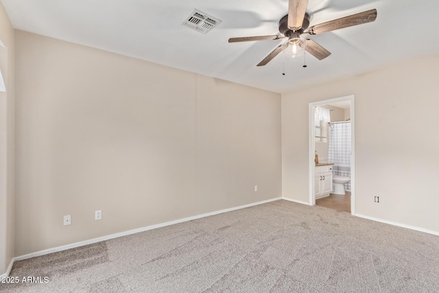 empty room with carpet floors, visible vents, ceiling fan, and baseboards