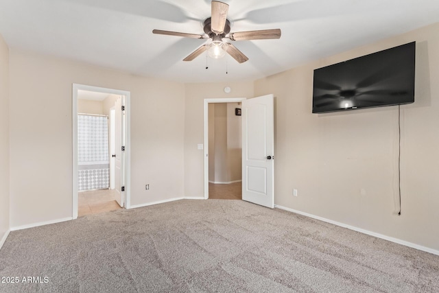 unfurnished bedroom with ensuite bath, carpet, baseboards, and ceiling fan