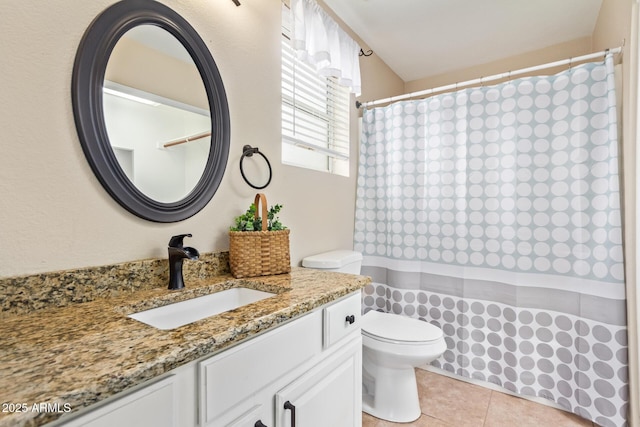 bathroom with toilet, a shower with curtain, vanity, and tile patterned floors