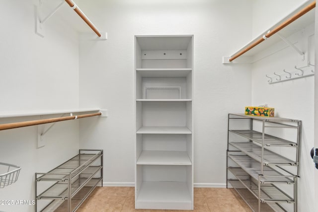 spacious closet featuring tile patterned floors