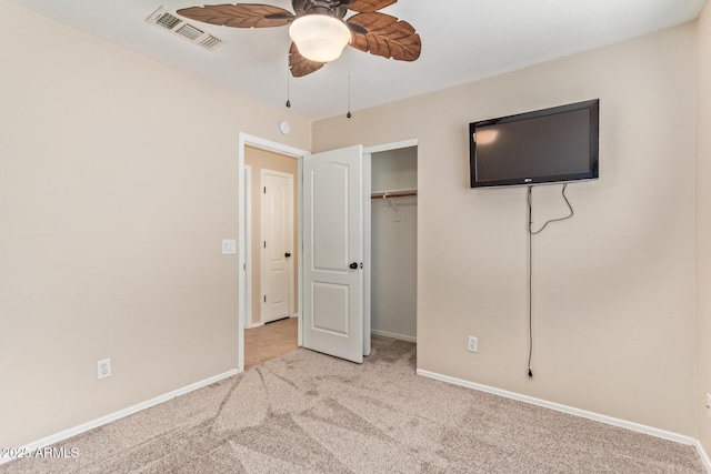 unfurnished bedroom featuring baseboards, visible vents, a ceiling fan, carpet floors, and a closet