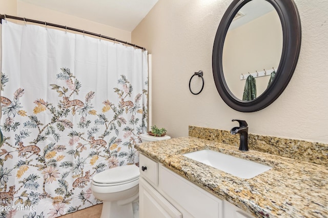 bathroom featuring a textured wall, toilet, curtained shower, tile patterned flooring, and vanity