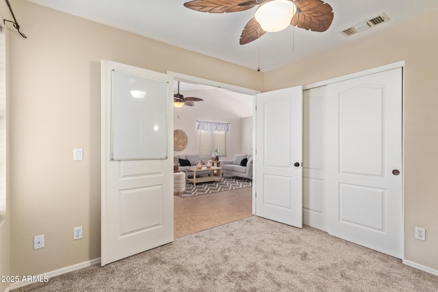 bedroom featuring a ceiling fan, a closet, visible vents, and carpet flooring