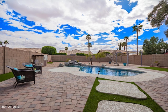 view of swimming pool with a fenced in pool, a fenced backyard, and a patio