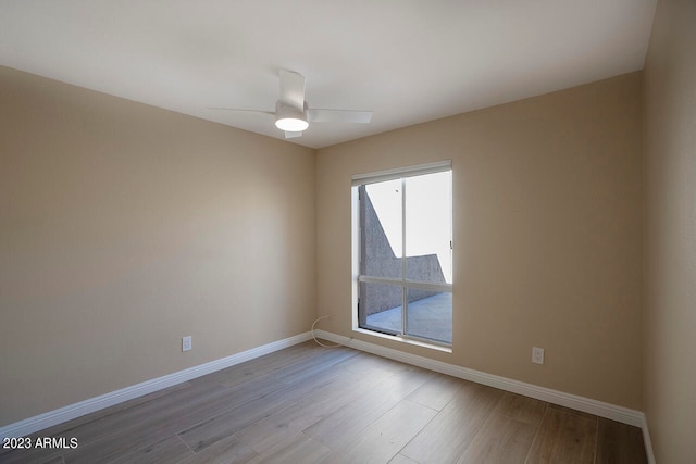 empty room with light wood-type flooring and ceiling fan