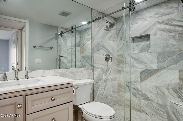 bathroom with toilet, a shower with shower door, vanity, and tile walls