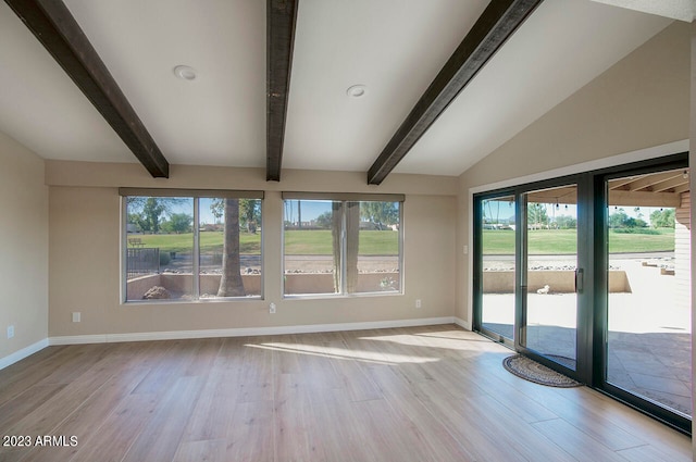 unfurnished room featuring light hardwood / wood-style flooring and lofted ceiling with beams