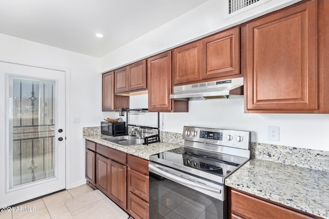 kitchen with light tile patterned flooring, stainless steel electric stove, light stone countertops, and sink