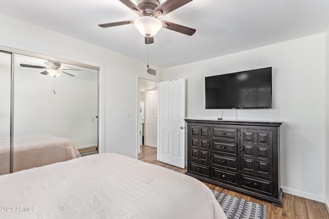 bedroom featuring ceiling fan, hardwood / wood-style flooring, and a closet