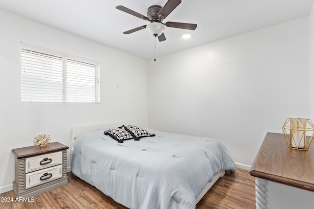 bedroom with ceiling fan and hardwood / wood-style flooring