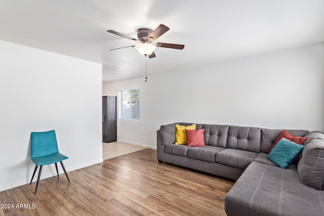 living room featuring ceiling fan and light wood-type flooring