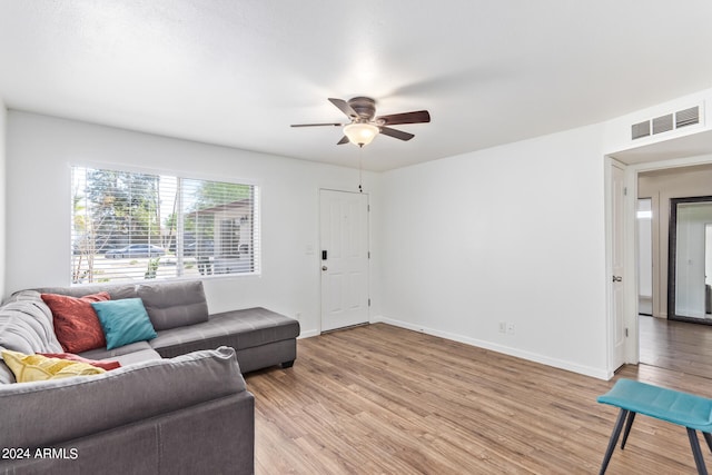 living room featuring ceiling fan and light wood-type flooring