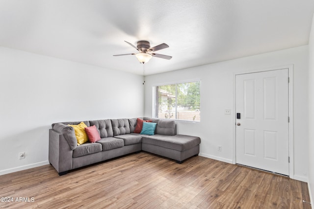 living room featuring light hardwood / wood-style floors and ceiling fan