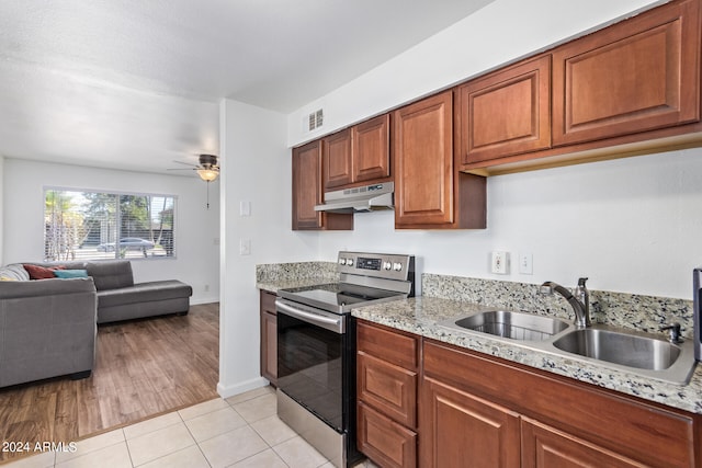 kitchen featuring ceiling fan, light wood-type flooring, sink, electric stove, and light stone countertops