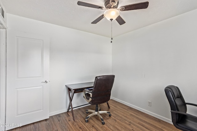 office area with a textured ceiling, ceiling fan, and dark hardwood / wood-style flooring