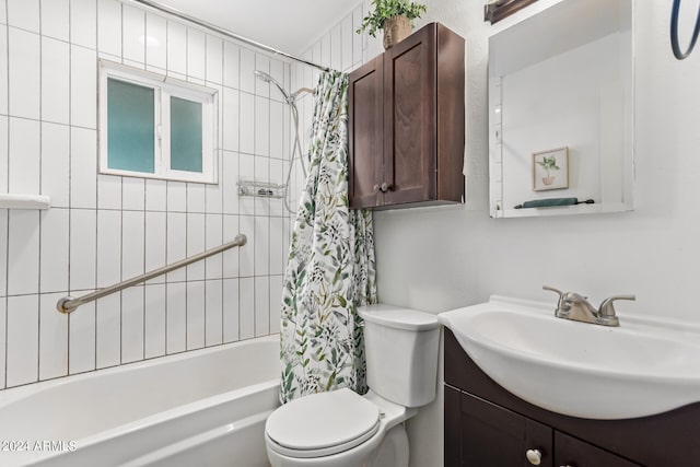 full bathroom featuring shower / bath combo, vanity, and toilet