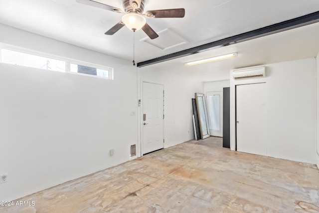 unfurnished bedroom featuring an AC wall unit and ceiling fan