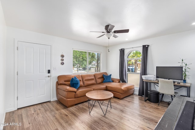 living room with a healthy amount of sunlight, wood-type flooring, and ceiling fan