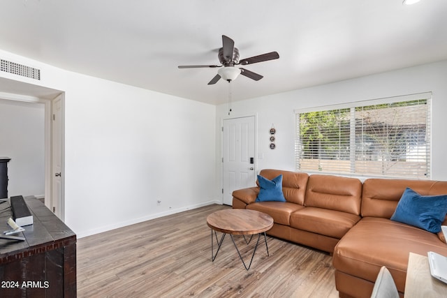 living room featuring light hardwood / wood-style flooring and ceiling fan