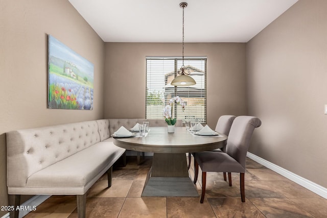 dining space featuring breakfast area and baseboards