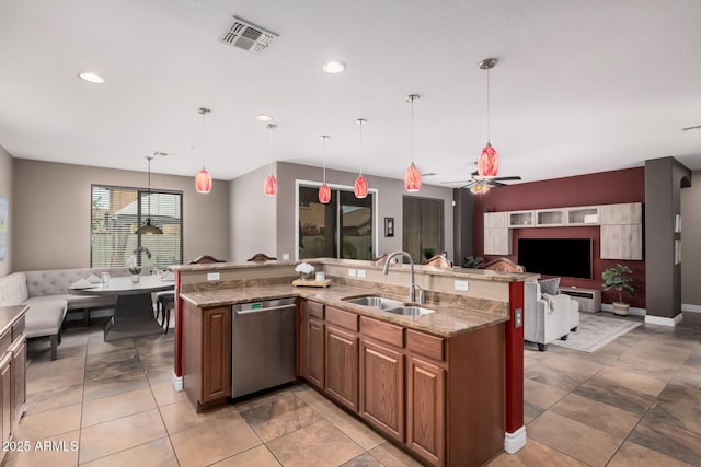 kitchen featuring visible vents, a sink, open floor plan, light stone countertops, and dishwasher