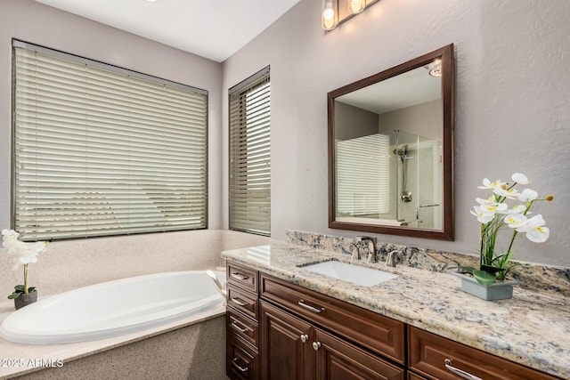 bathroom with vanity, a bath, and walk in shower