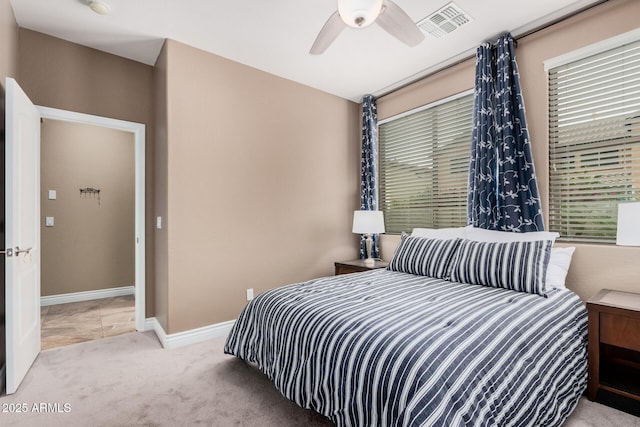 bedroom with visible vents, carpet floors, baseboards, and a ceiling fan