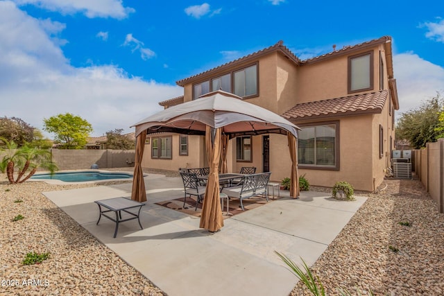 back of house with a fenced backyard, stucco siding, and a patio