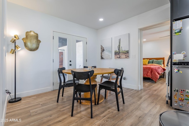 dining area with light wood-style floors, recessed lighting, baseboards, and french doors